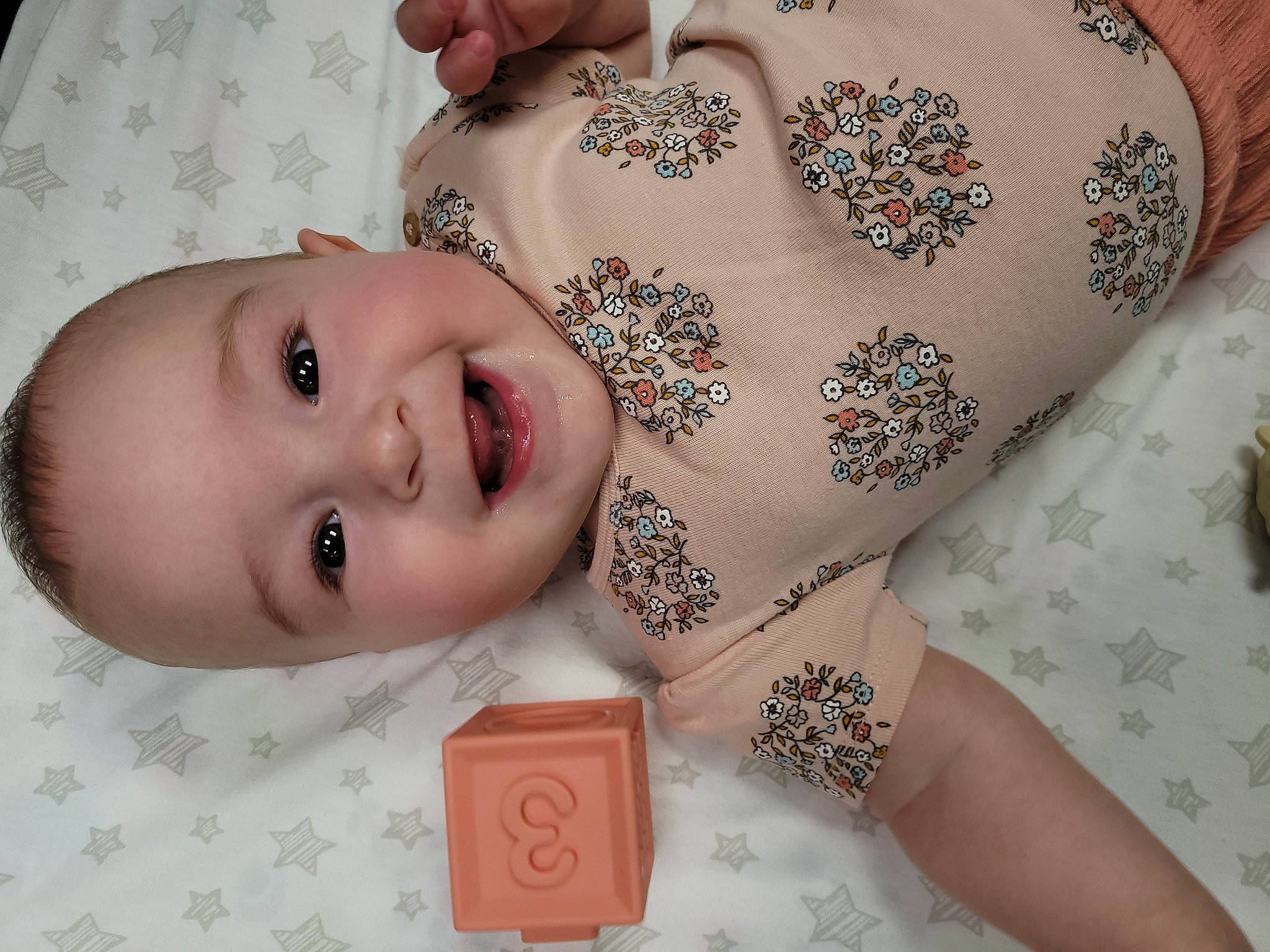 Sylvia is registered to the contest to win money with this photo: baby, baby_toddler_clothing, cheek, child, fashion_accessory, finger, hand, head, joy, nail, person, pink, product, skin, toddler