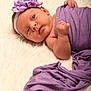 Lynaïa participe au concours pour gagner de l'argent avec cette photo : baby, infant, purple_cloth, headband, flower, wrapped, lying_down, fluffy_surface, cute, newborn, portrait, soft_texture, hand, face, skin, eyes, adorable, sleepwear, resting, peaceful