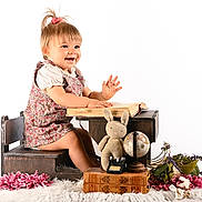 Lyana participe au concours pour gagner de l'argent avec cette photo : antique_books, book, child, childrens_furniture, cute, dress, flowers, globe, happy, indoor, knitted_bunny, pink_flowers, playing, portrait, smiling, toddler, toy_typewriter, white_background, wooden_desk, wooden_floor