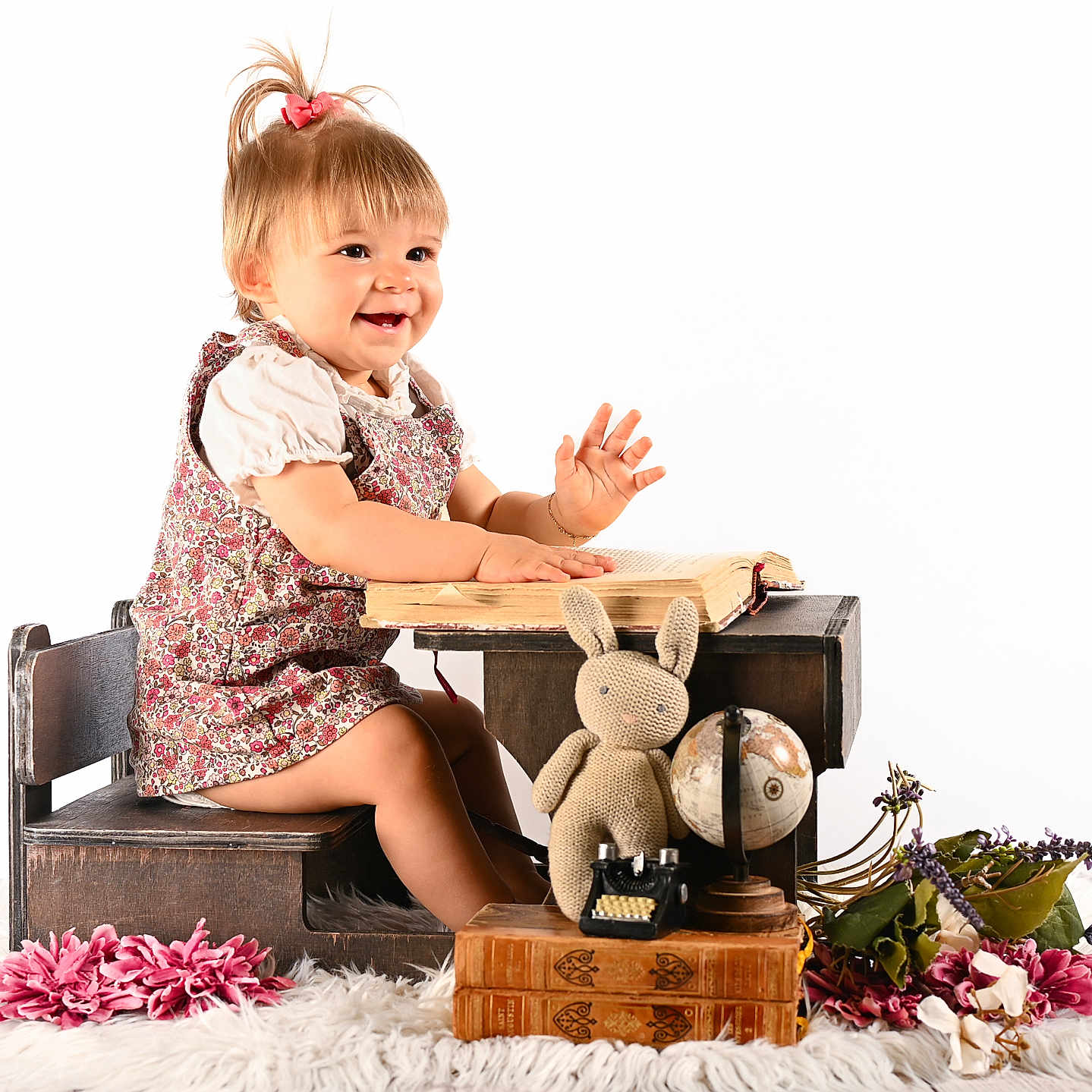 Lyana participe au concours pour gagner de l'argent avec cette photo : antique_books, book, child, childrens_furniture, cute, dress, flowers, globe, happy, indoor, knitted_bunny, pink_flowers, playing, portrait, smiling, toddler, toy_typewriter, white_background, wooden_desk, wooden_floor