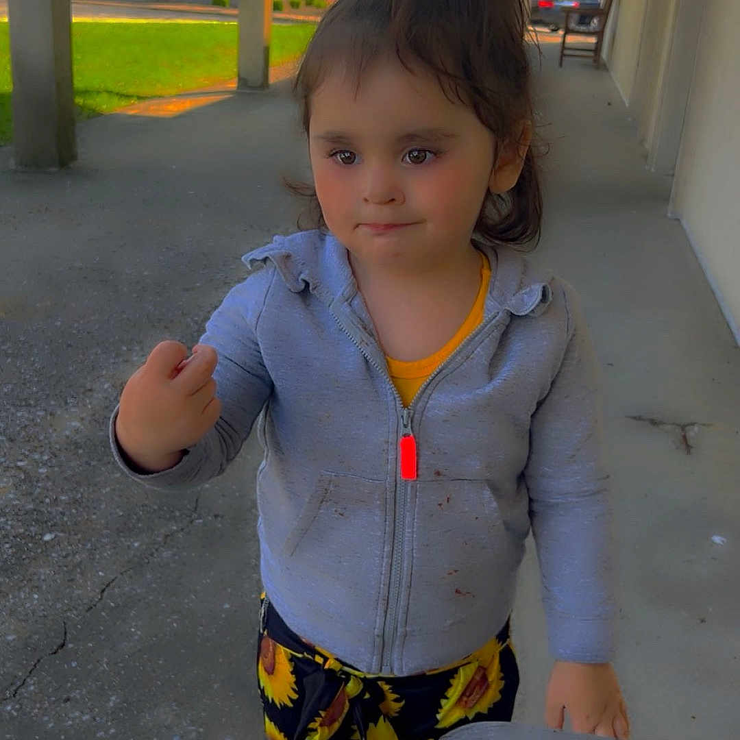 Angelina is registered to the contest to win money with this photo: child, city, clothing, coat, face, female, girl, grass, head, jacket, knitwear, pants, person, photography, plant, portrait, road, shorts, street, urban