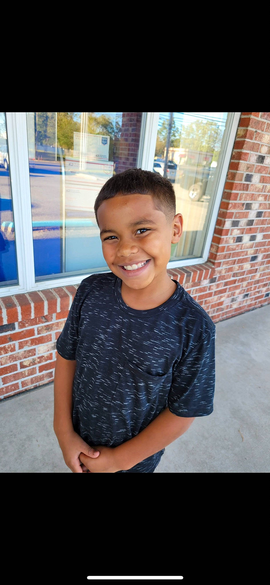 Omari joined the competition — help win amazing prizes! black_hair, child, elbow, eye, face, fun, happy, joy, laugh, leisure, pattern, person, sitting, skin, sleeve, smile, t_shirt, temple, toddler, travel