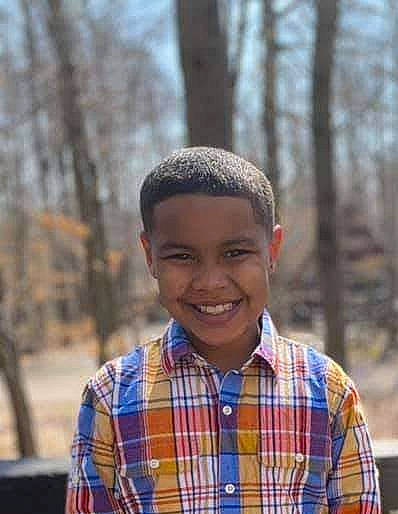 Omari is registered to the contest to win money with this photo: beauty, child, electric_blue, eye, forehead, fun, grass, hair, happy, joy, laugh, pattern, people, person, plaid, smile, spring, street_fashion, tartan, tree