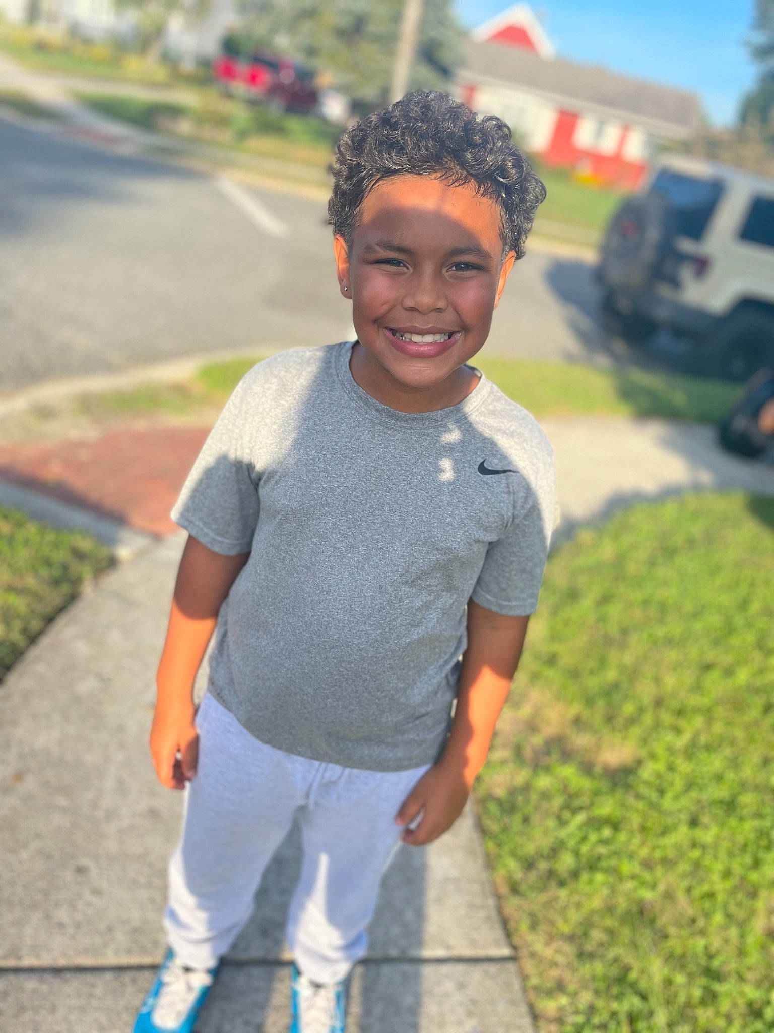 Omari joined the competition — help win amazing prizes! asphalt, child, cool, electric_blue, eyewear, fun, grass, hairstyle, happy, joy, leaf, leisure, pattern, person, plant, recreation, road, sleeve, smile, street_fashion