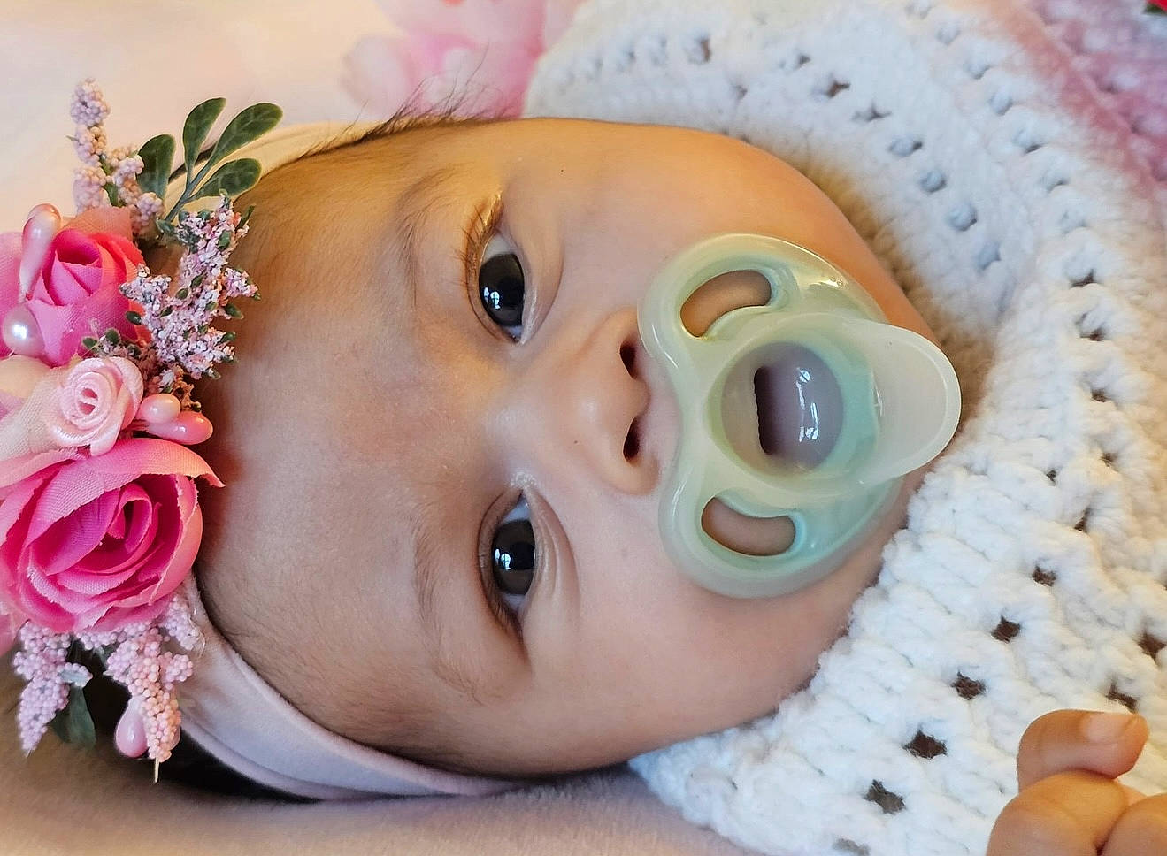 Cattaleya Rose is registered to the contest to win money with this photo: adorable, baby, blanket, child, closeup, cute, face, flower, hand, headband, infant, knitwear, pacifier, pink, portrait, resting, skin, sleepy, soft, young