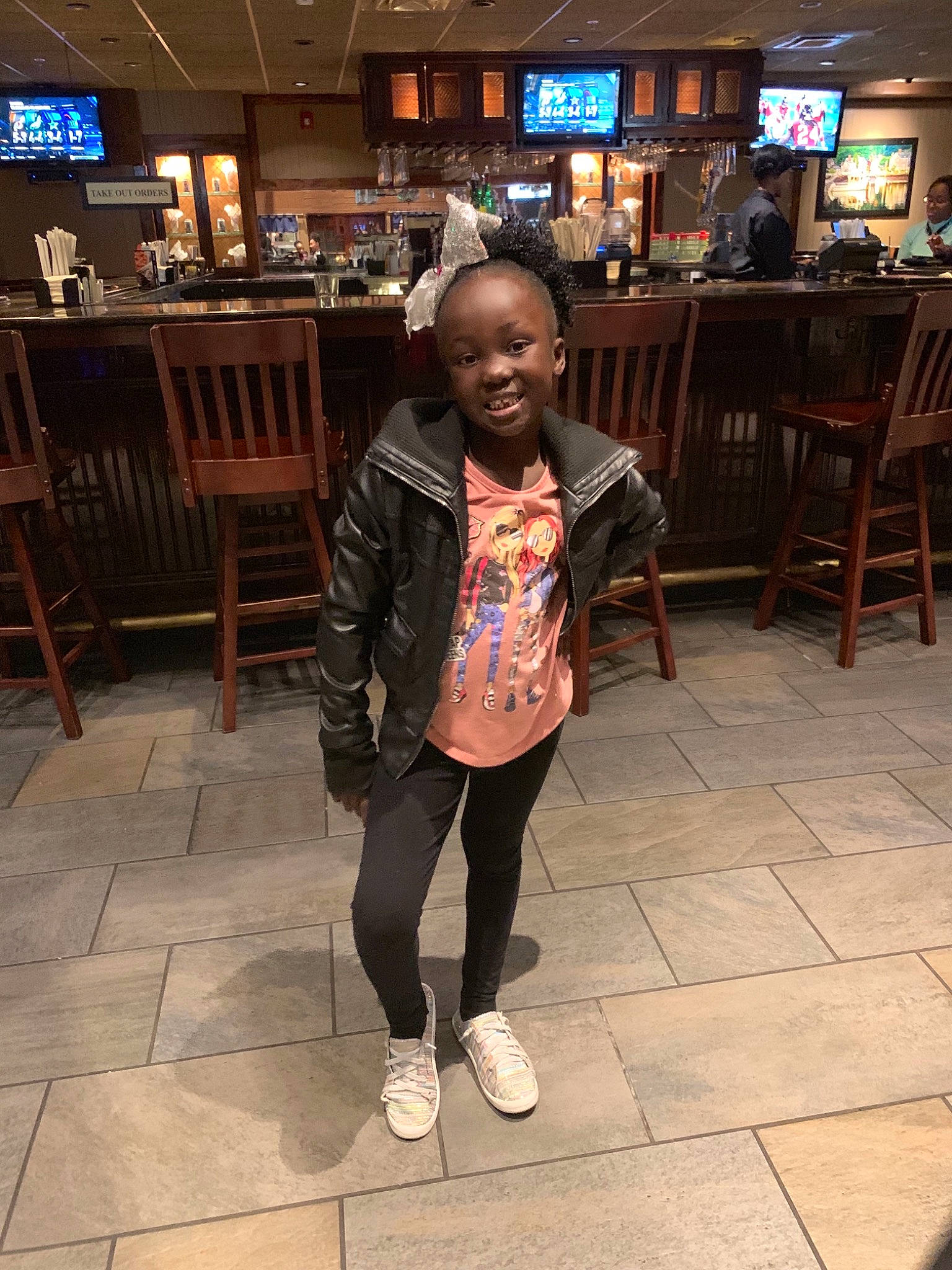 Miranda is registered to the contest to win money with this photo: child, fashion, flooring, footwear, fun, girl, joy, outerwear, person, product, recreation, road, shoe, smile, snapshot, standing, street