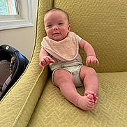 Bryson joined the competition — help win amazing prizes! baby, child, infant, smiling, armchair, green, bib, onesie, indoors, window, natural_light, happy, cute, skin, furniture, seated, foot, hand, face, expression