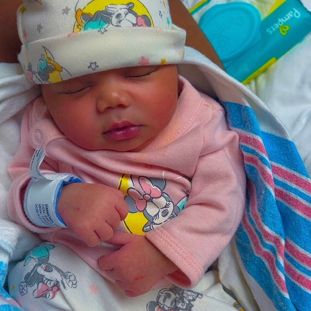 Saniyah joined the competition — help win amazing prizes! baby, blanket, blue, bow, child, clothing, cozy, cute, hat, hospital, infant, newborn, pajamas, pattern, person, pink, portrait, sleeping, white, wristband