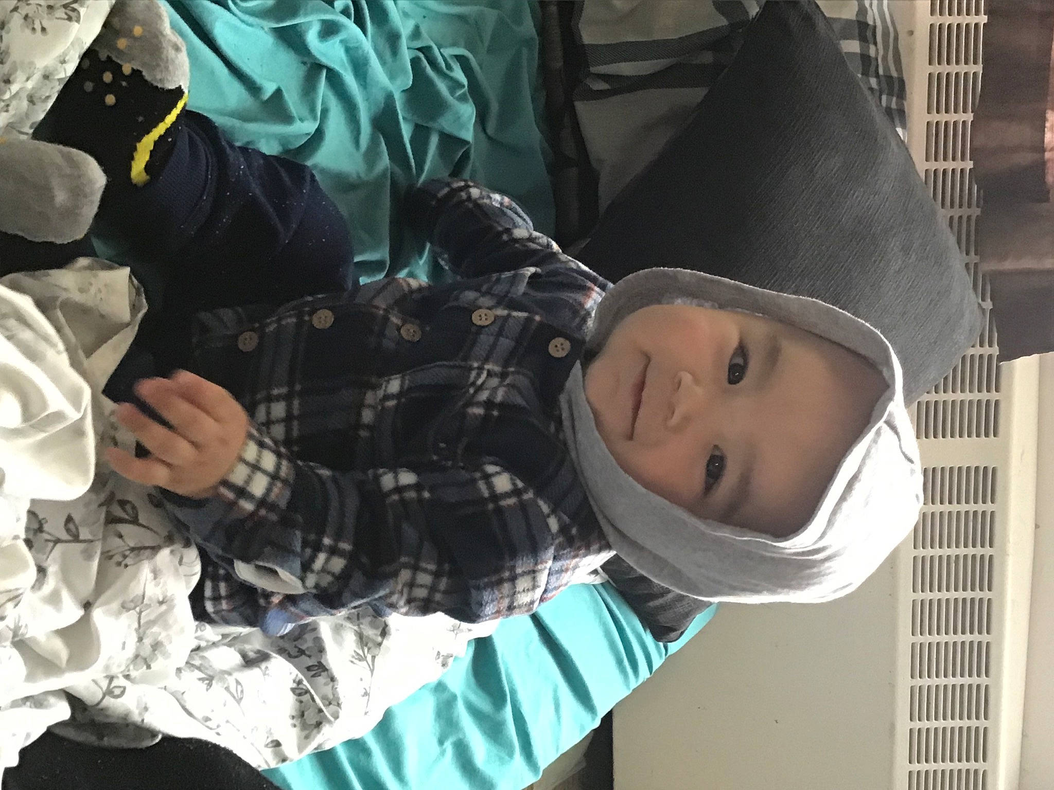 Jordan is registered to the contest to win money with this photo: baby, cap, child, cool, fashion_accessory, hat, headgear, headwear, human, outerwear, pattern, people, person, plaid, plant, product, smile, sun_hat, tartan, toddler