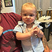Keaton joined the competition — help win amazing prizes! toddler, child, person, shirt, chain_necklace, tattoo, adult, arm, indoor, home, decor, curtain, picture_frame, furniture, table, casual, portrait, expression, holding, family