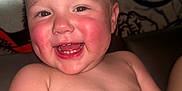 Keaton joined the competition — help win amazing prizes! baby, child, smiling, happy, rosy_cheeks, toothy_grin, bare_chest, dinosaur_background, indoor, cute, infant, portrait, young_child, playful, close_up, cheerful, skin, face, sitting, joyful