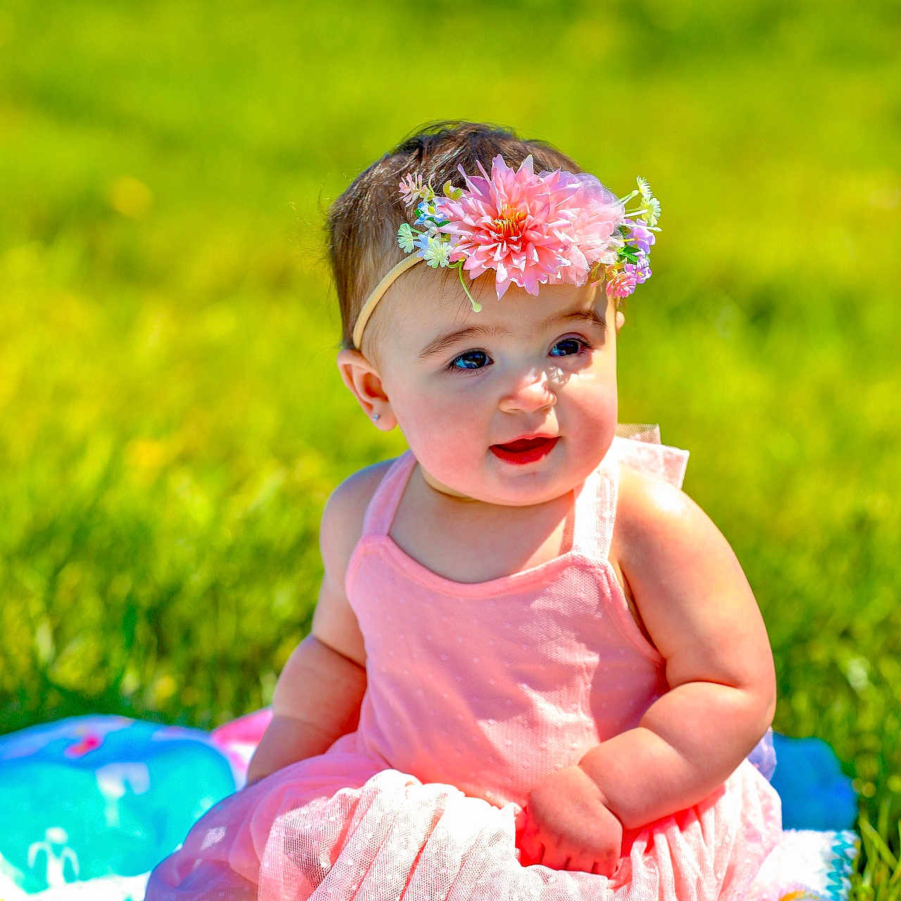 Scarlett is registered to the contest to win money with this photo: accessories, baby, clothing, dress, face, flower, flowerarrangement, grass, happy, head, lawn, outdoors, person, petal, photography, plant, portrait, sitting, smile, summer