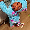 toddler, child, costume, blue, pink, playpen, wooden_floor, curious, indoors, baby, person, cute, wide_eyes, floor, cardboard_box, home, clothing, portrait, infant, expression