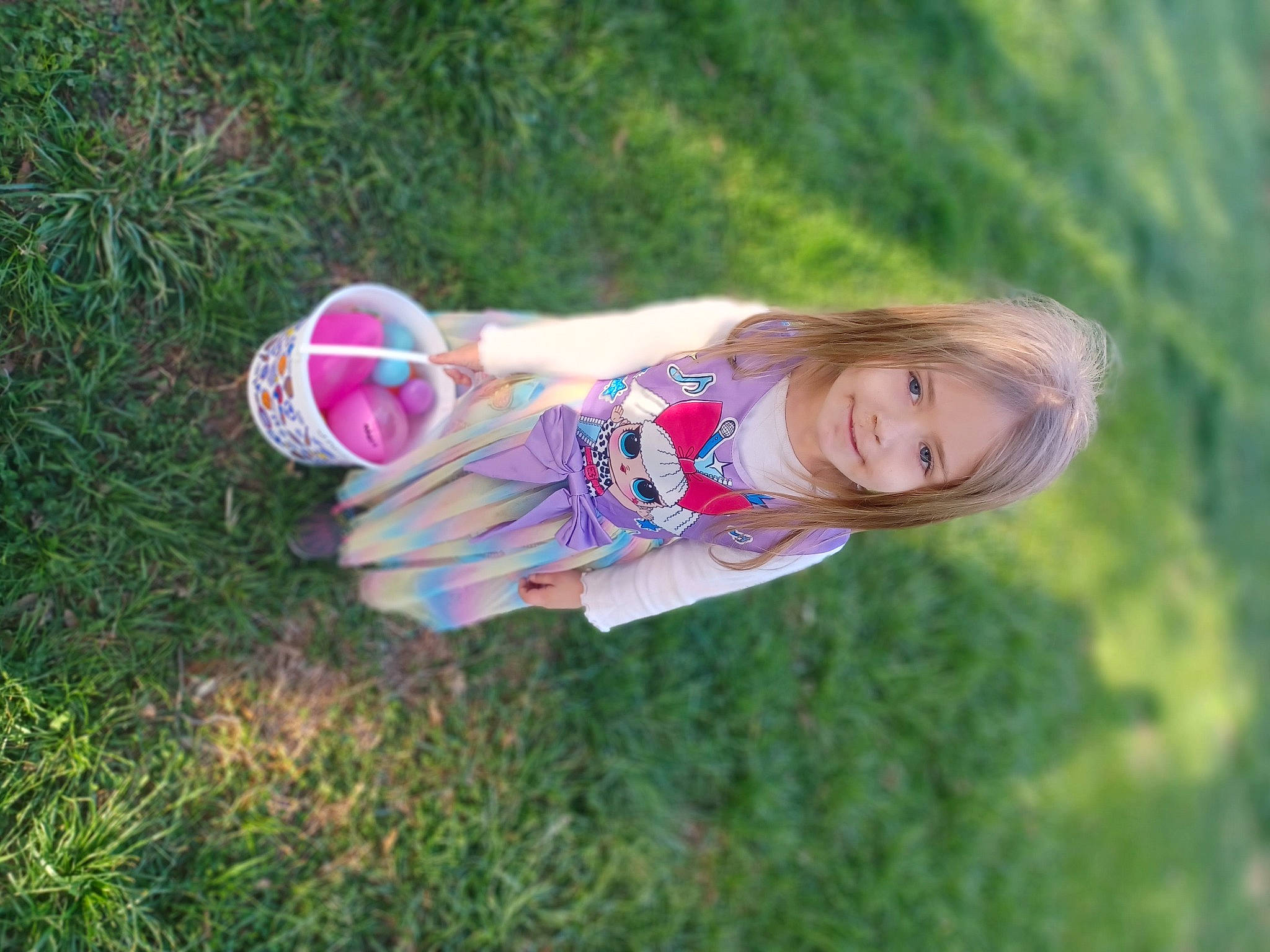 Jamie is registered to the contest to win money with this photo: face, flash_photography, fun, grass, grass_family, grassland, happy, joy, leisure, magenta, meadow, people_in_nature, person, pink, plant, prairie, recreation, smile, spring, sunlight