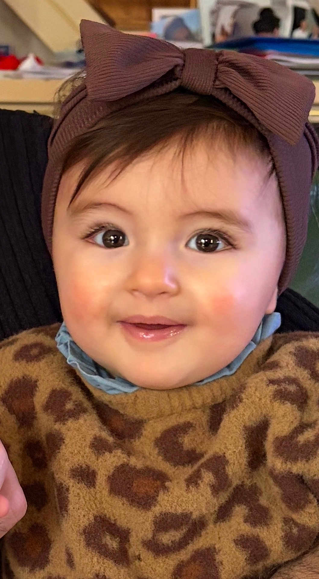 Ava participe au concours pour gagner de l'argent avec cette photo : baby, bow, child, closeup, clothing, cute, eyes, face, fuzzy, happy, headband, headwear, indoor, leopard_print, person, portrait, smile, sweater, warm, young_child