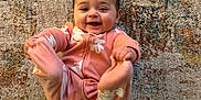 Elara joined the competition — help win amazing prizes! baby, carpet, child, cozy, cute, expression, face, feet, floor, floral_pattern, hands, happy, indoors, infant, lying_down, person, pink_onesie, playful, smiling, young
