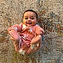 baby, infant, smiling, pink_onesie, floral_pattern, carpet, floor, happy, cute, child, person, indoors, playful, lying_down, hands, feet, face, expression, cozy, young