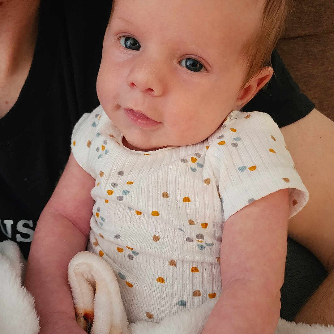 Henry joined the competition — help win amazing prizes! baby, blanket, bodypart, clothing, couch, cushion, face, finger, furniture, hand, happy, head, homedecor, newborn, person, photography, portrait, sitting, smile, t_shirt
