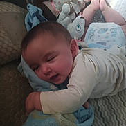 Ruthanne is registered to the contest to win money with this photo: baby, bed, blanket, child, comfort, cozy, crawling, cute, diaper, fabric, feet, indoors, infant, pattern, person, plush_toy, resting, sleepy, soft_toy, toddler