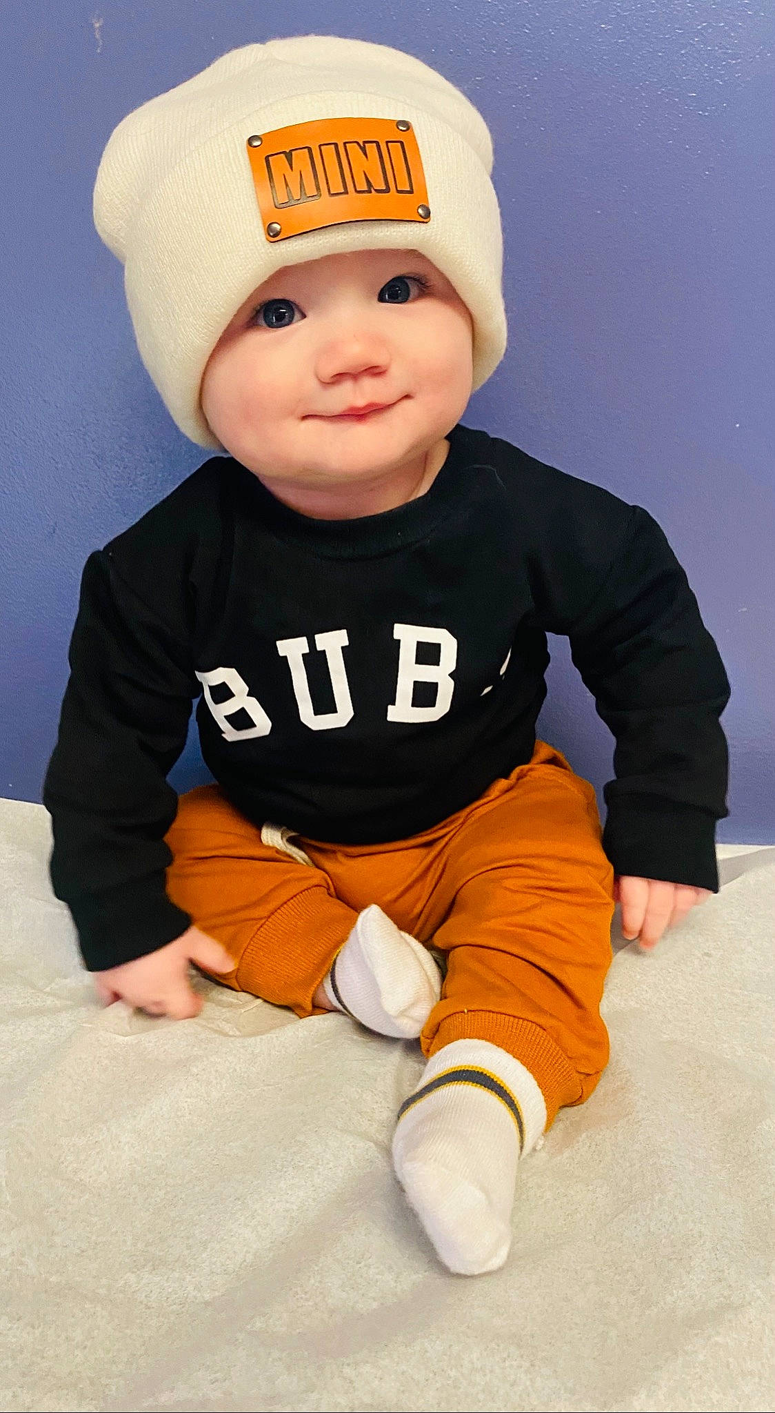 Walker joined the competition — help win amazing prizes! baby, baby_toddler_clothing, baseball_cap, beanie, cap, cheek, child, costume_accessory, face, happy, hat, headgear, headwear, peach, person, portrait_photography, sitting, sleeve, smile, t_shirt