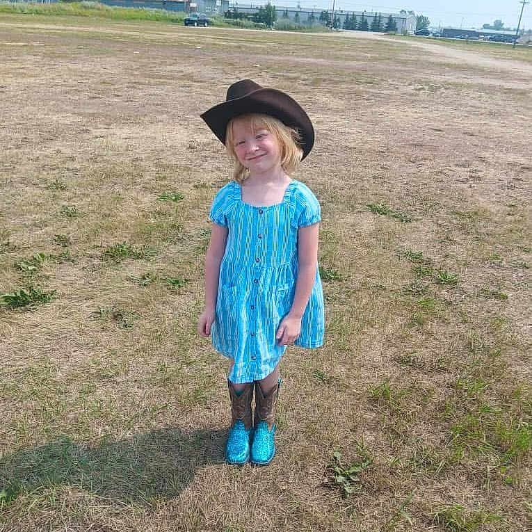 Willow is registered to the contest to win money with this photo: car, child, clothing, face, female, girl, grass, hat, head, lady, nature, outdoors, pants, person, photography, plant, portrait, standing, transportation, yard