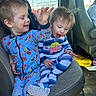 child, toddler, pajamas, car_seat, vehicle_interior, happy, playing, smiling, cute, seat, clothing, footwear, baby, expression, fun, sibling, indoor, daylight, transportation, casual