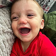 Bennett joined the competition — help win amazing prizes! baby, child, laughing, red_shirt, blanket, texture, cozy, happy, smiling, face, infant, closeup, indoor, expression, candid, cute, joy, portrait, soft, comfort