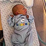 Austin joined the competition — help win amazing prizes! newborn, baby, infant, hospital, bassinet, onesie, clothing, sleeping, face, head, fist, cute, resting, blue, blanket, person, portrait, young, lying_down, healthcare