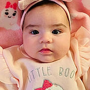Nathalia joined the competition — help win amazing prizes! baby, infant, headband, bow, pink_clothing, cute, face, portrait, soft_blanket, expressionless, baby_girl, closeup, lying_down, indoors, child, adorable, small_person, baby_outfit, text_on_clothing, pink_background