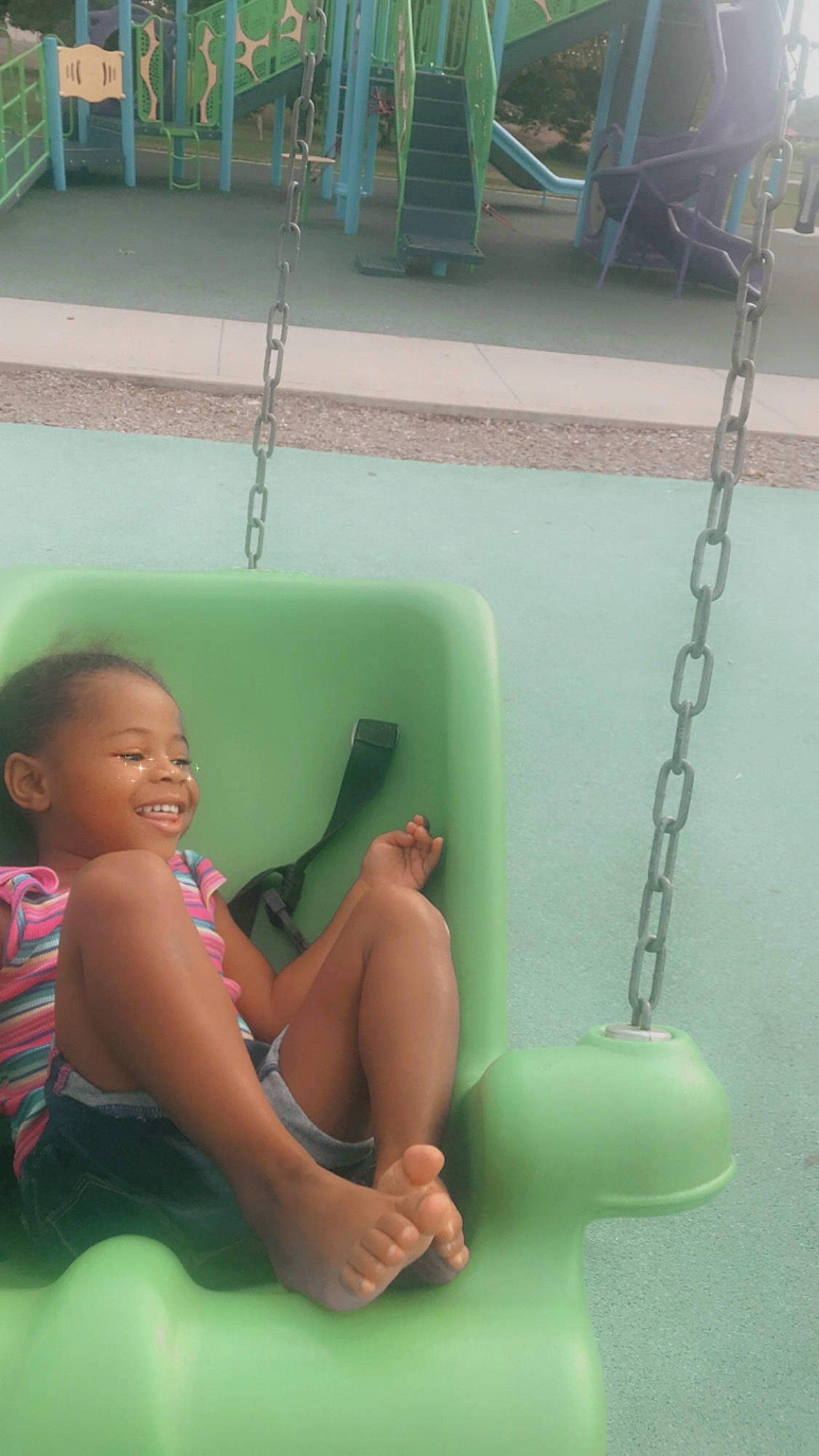 Amiya is registered to the contest to win money with this photo: bathing, child, fun, joy, leisure, outdoor_play_equipment, person, play, recreation, skin, smile, summer, swing, toddler, vacation