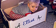 Elliot joined the competition — help win amazing prizes! candid, carpet, child, cute, dinosaur_stickers, face, floor, gray_shirt, hair, home, indoor, light, personalized, playing, smiling, striped_pants, toddler, toy_chest, toy_trucks, wooden_furniture