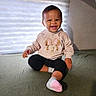 baby, bed, bedding, black_pants, cartoon, child, cozy, happy, home, hoodie, indoors, infant, minnie_mouse, natural_light, pink, portrait, sitting, smiling, socks, window