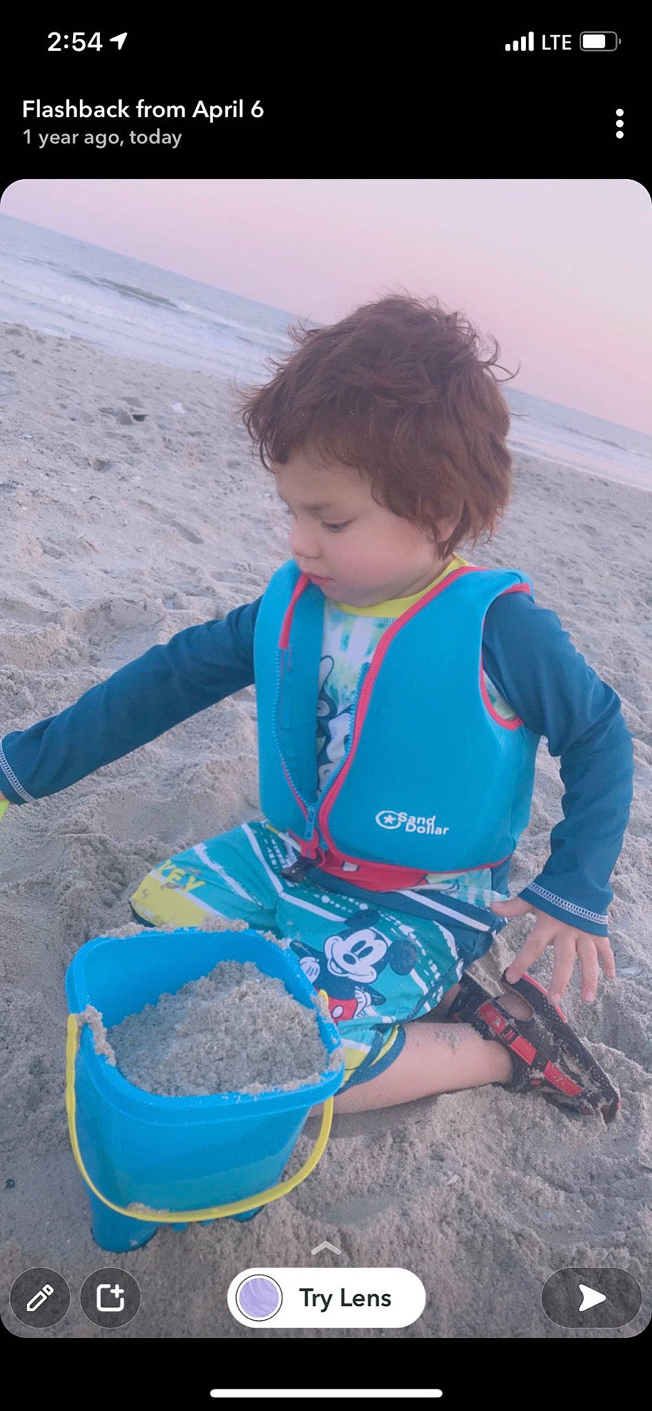 Liam is registered to the contest to win money with this photo: baby_toddler_clothing, beach, bucket, child, electric_blue, fun, landscape, leisure, people_in_nature, person, photograph, play, recreation, sand, sitting, sleeve, soil, t_shirt, toddler, travel