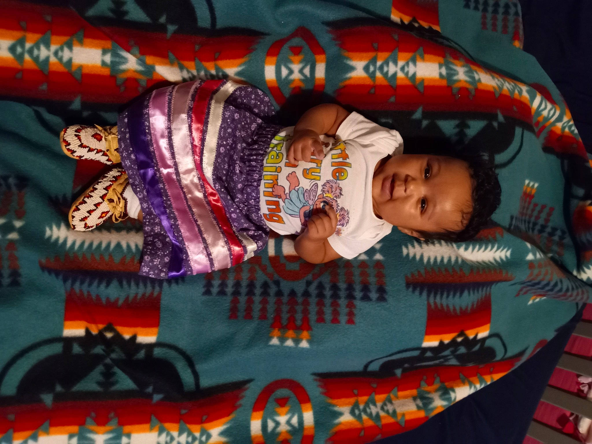 Sarah is registered to the contest to win money with this photo: art, baby, baby_products, baby_toddler_clothing, cheek, child, craft, event, fun, happy, linens, magenta, pattern, person, room, textile, toddler, tradition, visual_arts, world