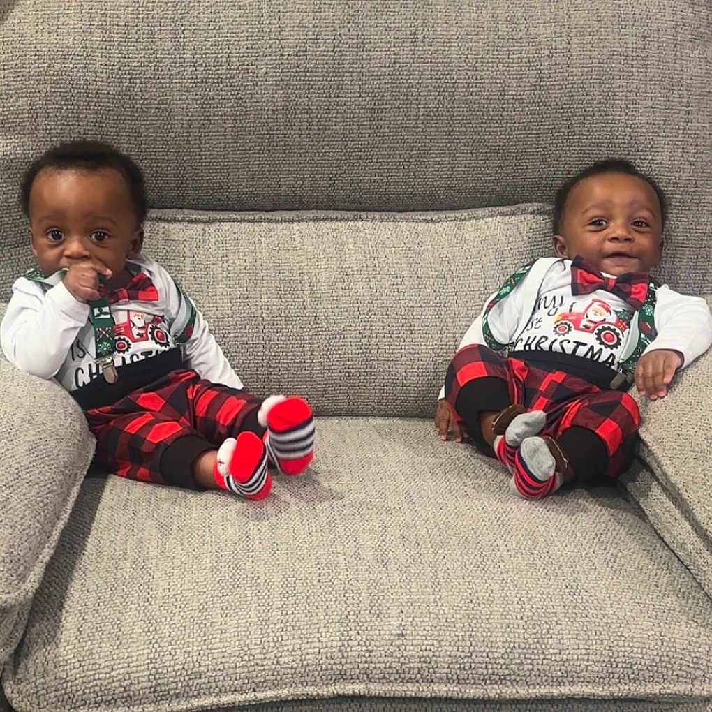Brandon N Braxton is registered to the contest to win money with this photo: baby, child, christmas, clothing, couch, cute, face, furniture, happy, holiday_outfit, indoor, infant, matching_outfits, red_and_black_plaid, sitting, smile, socks, sofa, thumb_sucking, two_children