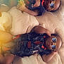 baby, infant, sunglasses, blanket, bed, sleeping, clothing, pacifier, cool, cute, child, indoors, relaxing, two_children, toddler, laying_down, soft_light, cozy, portrait, fashion