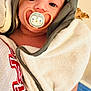baby, pacifier, towel, blanket, infant, wrapped, face, cute, indoors, bottle, lotion, nursery, wall_decor, teddy_bear, child, soft, comfort, portrait, person, calm