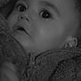 baby, infant, child, face, close_up, portrait, black_and_white, big_eyes, eyelashes, hood, fleece_jacket, zipper, hand, cheeks, cozy, soft_texture, blanket, heart_icon, date_stamp, indoor
