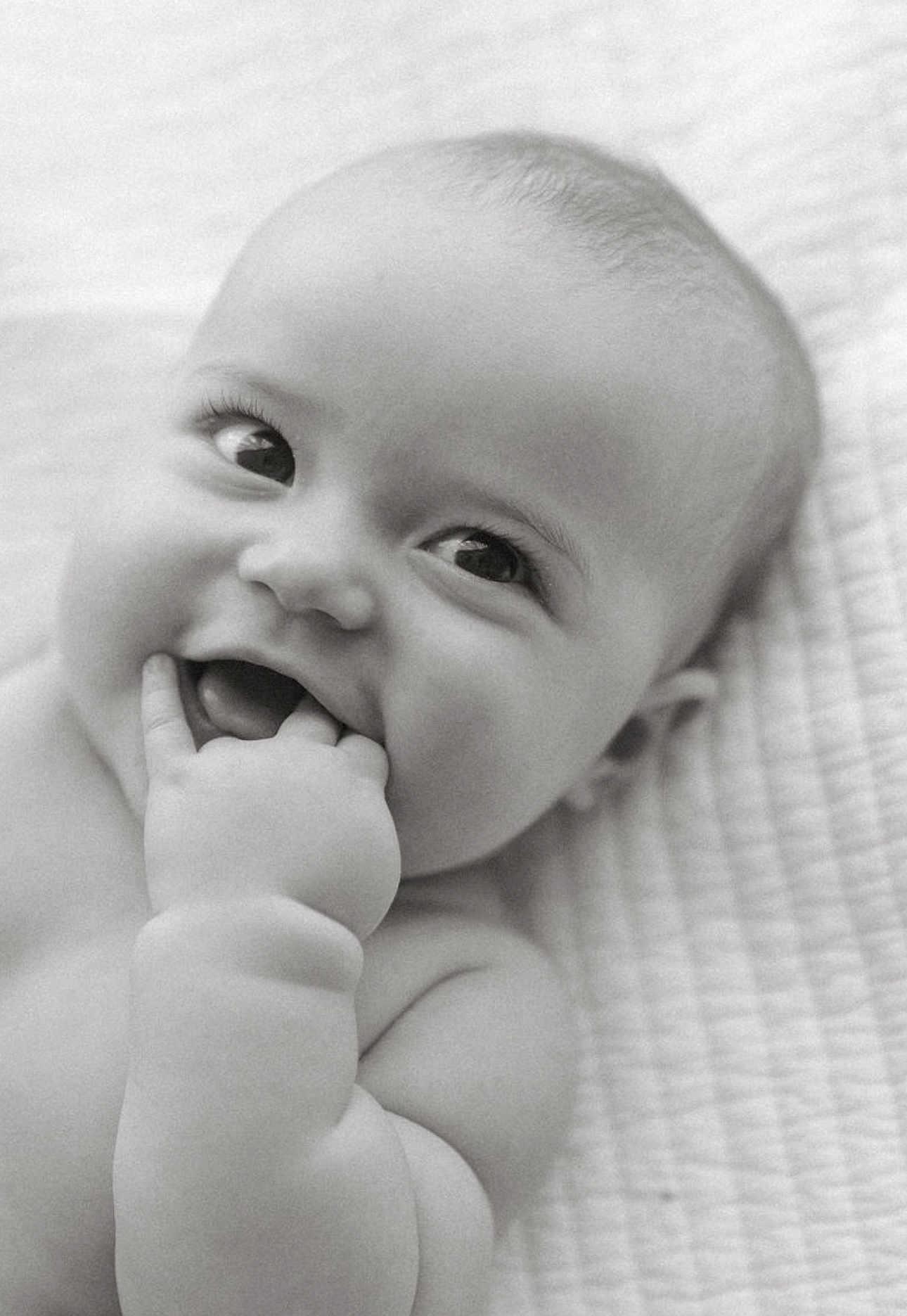 Collins joined the competition — help win amazing prizes! baby, infant, child, smiling, chewing, fingers, close_up, black_and_white, cute, happy, face, skin, lying_down, blanket, portrait, young, expression, innocence, soft, newborn