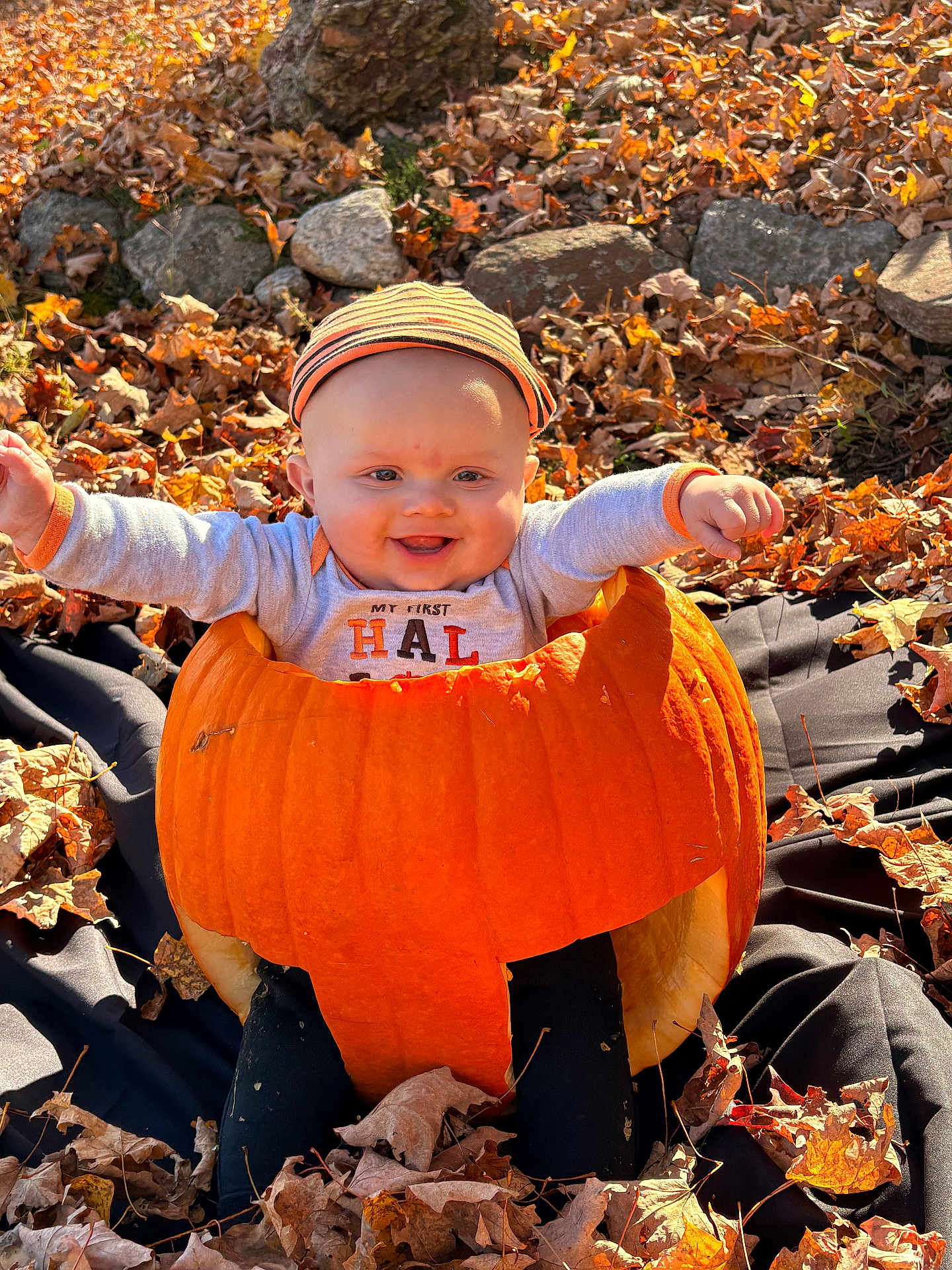Wyatt joined the competition — help win amazing prizes! baby, pumpkin, halloween, fall, autumn_leaves, outdoor, hat, rocks, smiling, happy, cute, child, seasonal, costume, orange, nature, sunlight, playful, sitting, festive