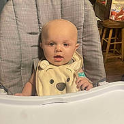 Wyatt is registered to the contest to win money with this photo: baby, high_chair, bib, smiling, indoor, child, face, furniture, seat, kitchen, expression, cute, young, person, infant, happy, clothing, table, room, household