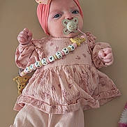 Kataleïa participe au concours pour gagner de l'argent avec cette photo : adorable, baby, beaded_pacifier_clip, bow, changing_pad, close_up, dress, fabric, floral_pattern, hands, headband, indoor, infant, leggings, newborn, pacifier, pink_clothing, portrait, soft_texture, toy