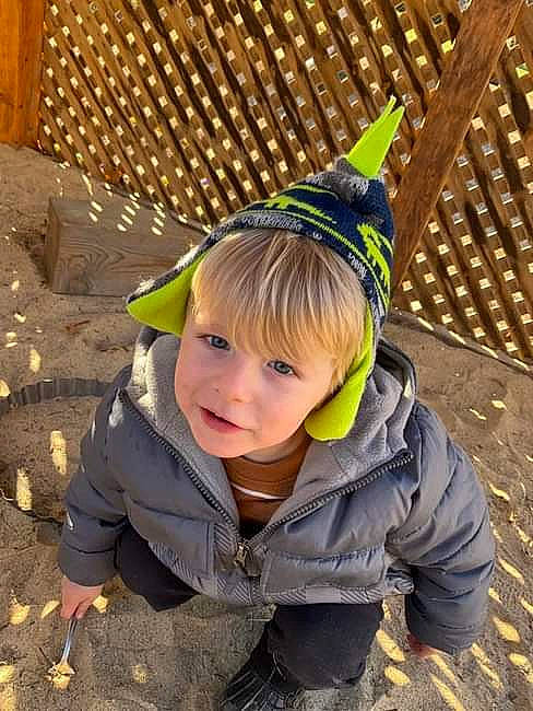 Declan joined the competition — help win amazing prizes! child, city, fashion_accessory, fun, grass, happy, headgear, hoodie, landscape, leisure, outerwear, party_hat, people_in_nature, person, play, recreation, sitting, soil, toddler, winter
