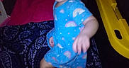 Aaryn is registered to the contest to win money with this photo: baby, blanket, blue_outfit, child, dark_background, face, family_photo, flash_photography, happy, indoor, infant, low_light, patterned_blanket, play_structure, portrait, rainbow_pattern, sitting, smiling, toy, yellow