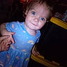 Aaryn is registered to the contest to win money with this photo: adult_hand, baby, blue_eyes, blue_outfit, camera_watermark, child, close_up, dim_lighting, dress, flash_photography, furniture, indoor, infant, leaning, playroom, portrait, rainbow, sitting, smiling, yellow_trim