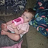 baby, blanket, blue_eyes, bottle, brown_hair, child, couch, cozy, drinking, fabric, feet, furniture, hands, home, indoors, infant, pink_clothing, portrait, relaxed, sitting