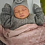 baby, sleeping, blanket, hat, bow, clothing, cozy, infant, child, soft, warm, peaceful, cute, knitwear, portrait, resting, indoors, pink_blanket, grey_sweater, newborn
