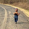 Aalaya is registered to the contest to win money with this photo: back_view, bare_trees, black_top, casual_clothing, child, grass, headband, jeans, kid, nature, outdoor, path, road, small_child, sunlight, toddler, trees, walking, walking_away, young_child