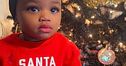 Aalaya joined the competition — help win amazing prizes! bow, celebration, child, christmas, christmas_tree, cute, decorations, festive_clothing, headband, holiday, holiday_season, indoors, lights, ornaments, portrait, red_shirt, smiling, striped_pants, toddler, young_child
