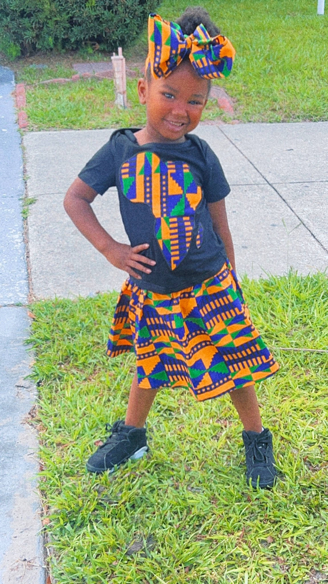 Ja'Kyra is registered to the contest to win money with this photo: baby_toddler_clothing, child, electric_blue, face, fun, grass, headwear, joy, magenta, pattern, person, plaid, plant, play, sandal, sleeve, t_shirt, tartan, toddler, waist